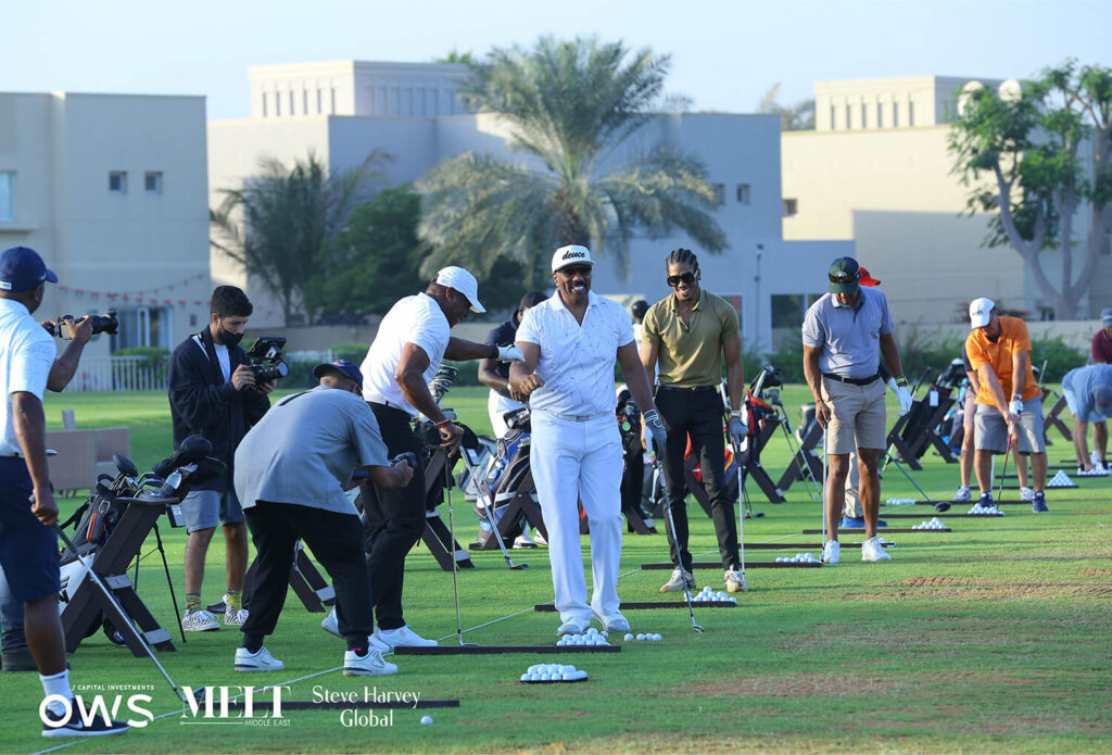 Steve Harvey at the driving range with participants