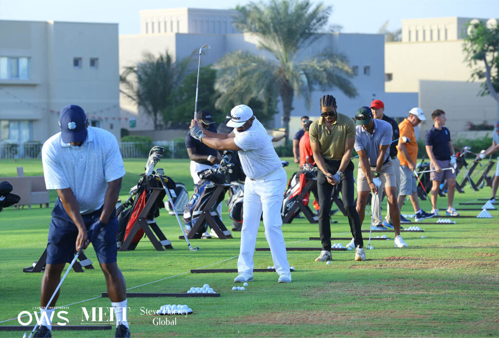 Golfers lined up to practice their swings