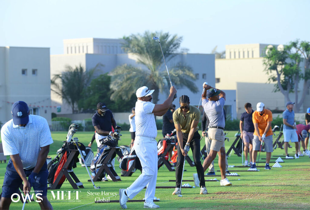 Golfers lined up to practice their swings