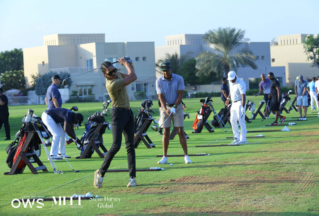 Golfers lined up to practice their swings