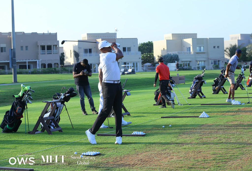 Golfers lined up to practice their swings
