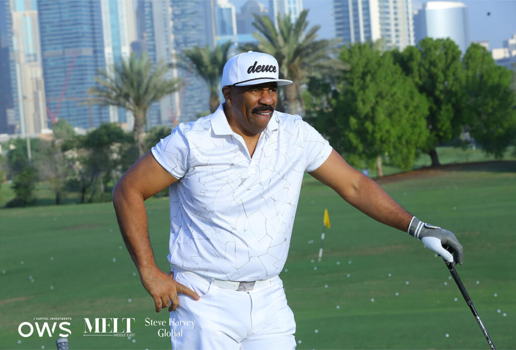 Steve Harvey posing with his club