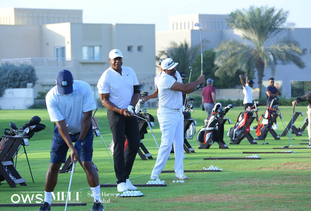 Golfers lined up to practice their swings