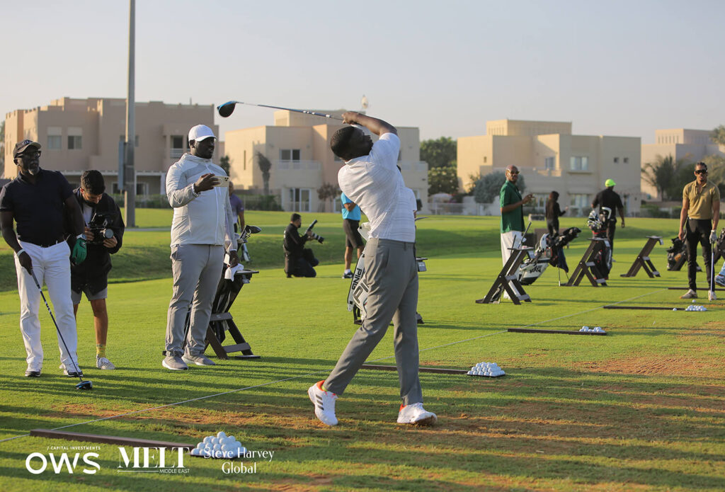 Golfers lined up to practice their swings