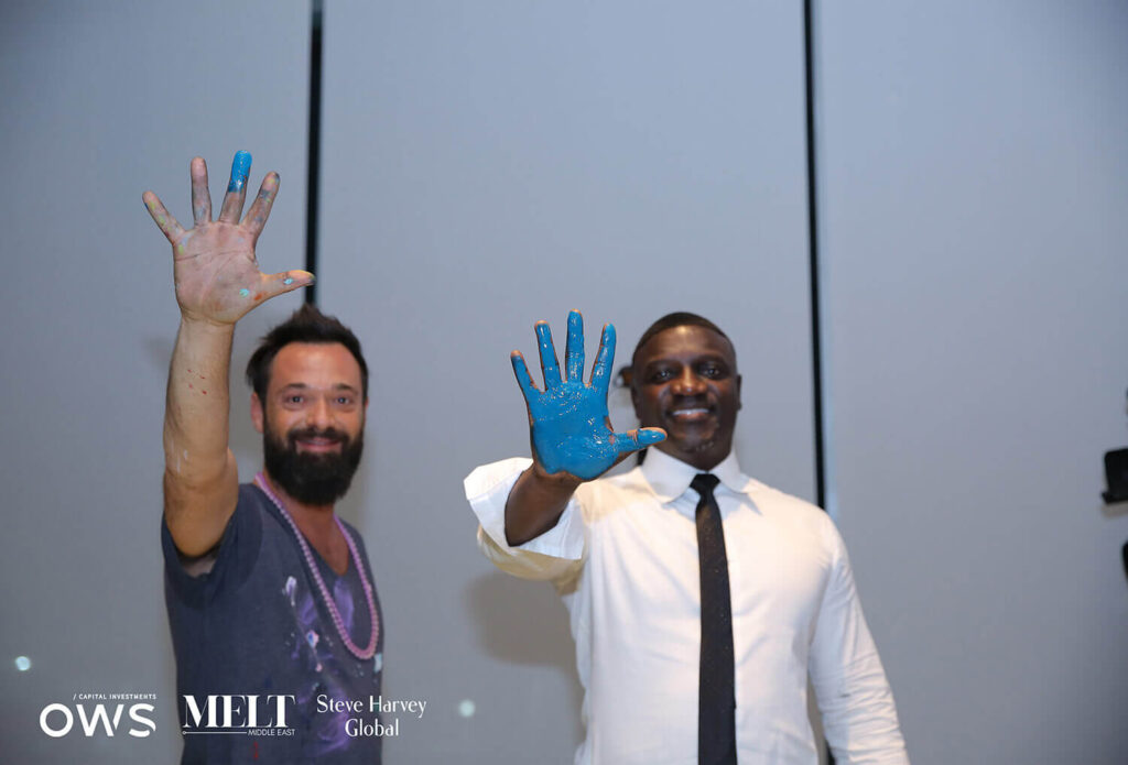 Artist with guest show their painted hands
