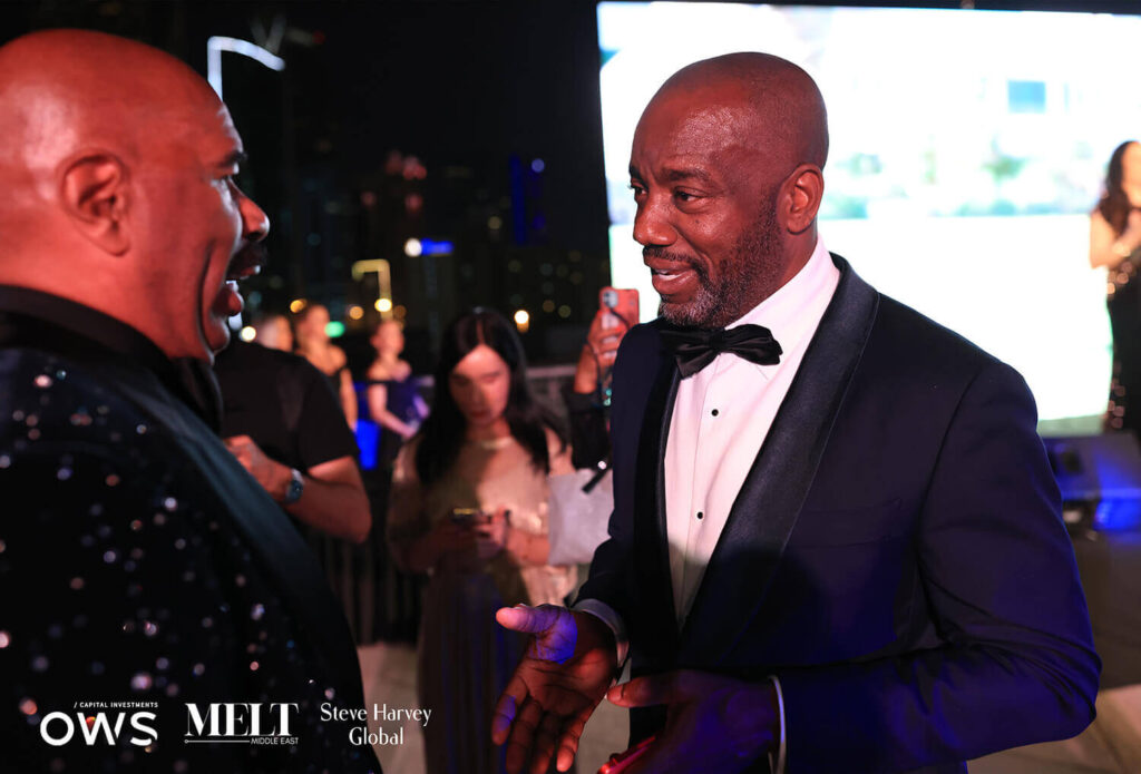 Steve Harvey speaking with a guest